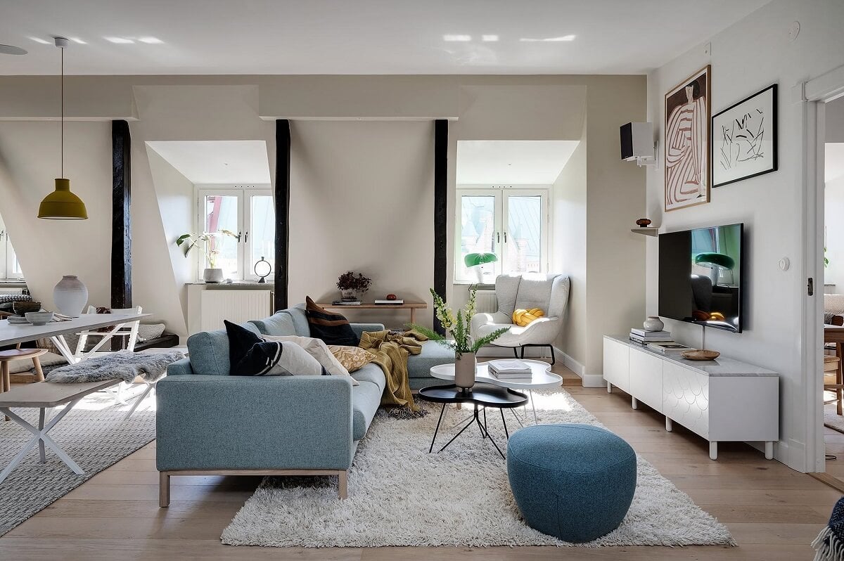 A Modern Scandinavian Attic Apartment 10 modern-living-room-light-blue-sofa-wooden-beams-nordroom
