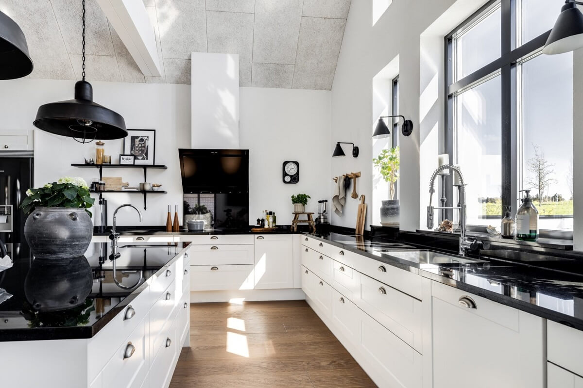 A Monochrome Swedish Villa with High Ceilings 16 monochrome-kitchen-white-cabinets-black-worktop-pendants-nordroom