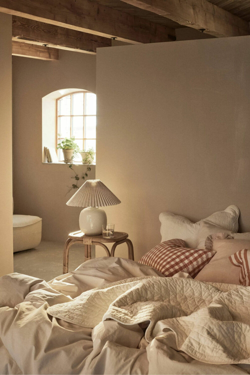 A Serene Summer House in Sweden 7 neutral-colored-bedroom-summer-house-exposed-beams-ellos-nordroom