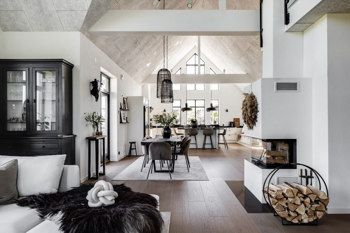 open-plan-living-space-kitchen-fireplace-monochrome-colors-high-ceiling-nordroom