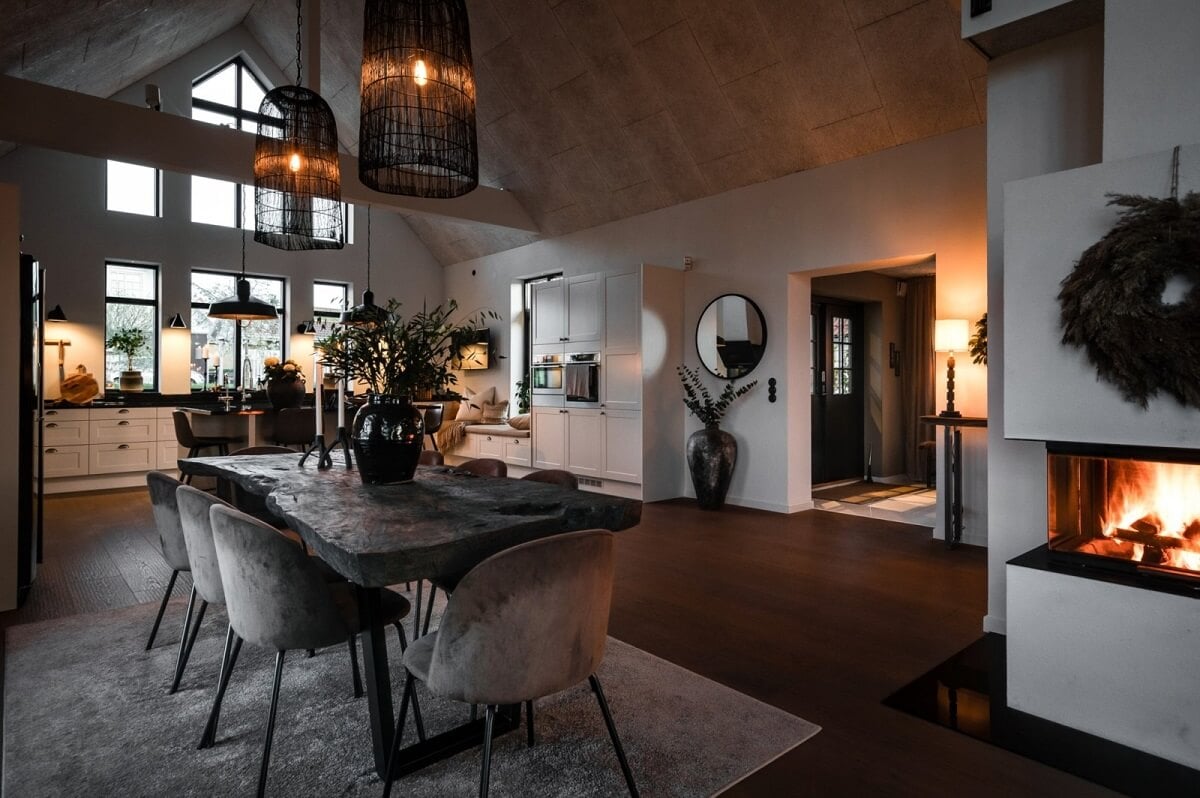 A Monochrome Swedish Villa with High Ceilings 8 open-plan-scandinavian-living-space-dining-table-high-vaulted-ceiling-at-night-nordroom