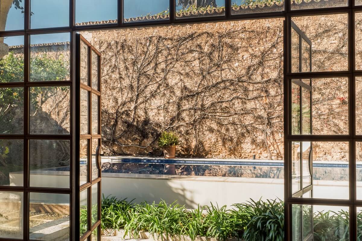 A Renovated Historic Townhouse on Mallorca 9 pool-view-steel-framed-glass-doors-nordroom