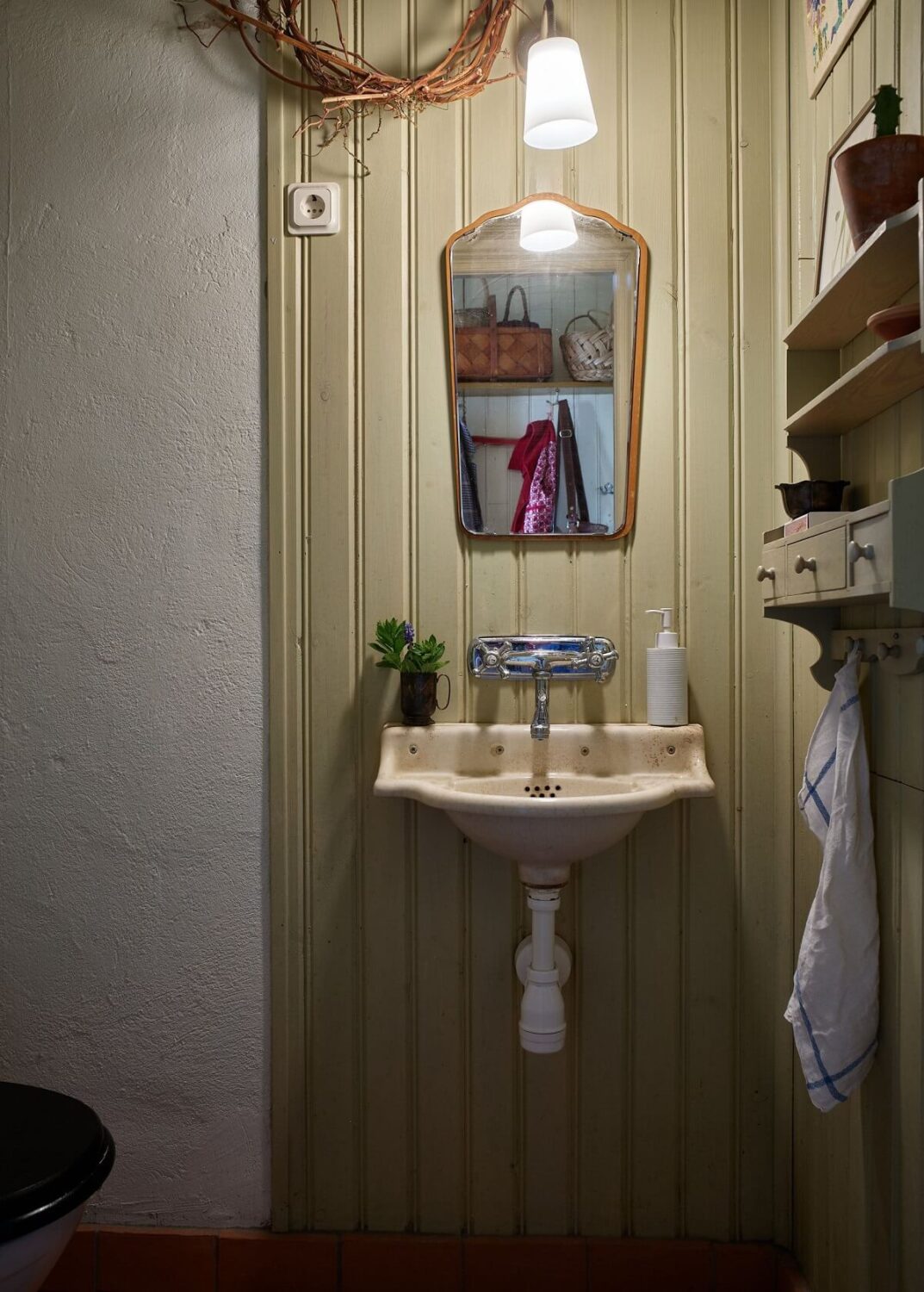 A Vintage Colorful Family Home in the Swedish Countryside 15 powder-room-light-green-wood-paneling-nordroom