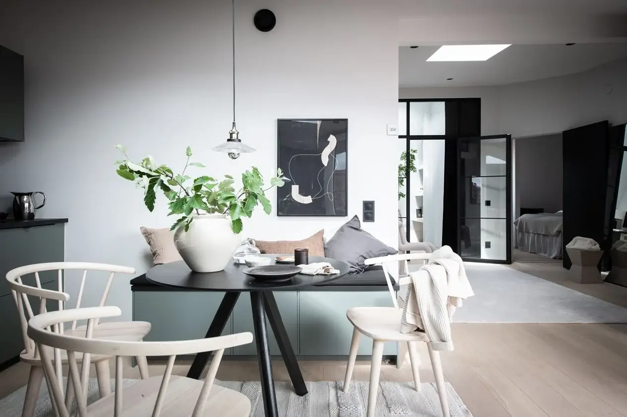 A Stylish Scandinavian Attic Apartment 9 round-black-dining-table-bench-with-storage-nordroom