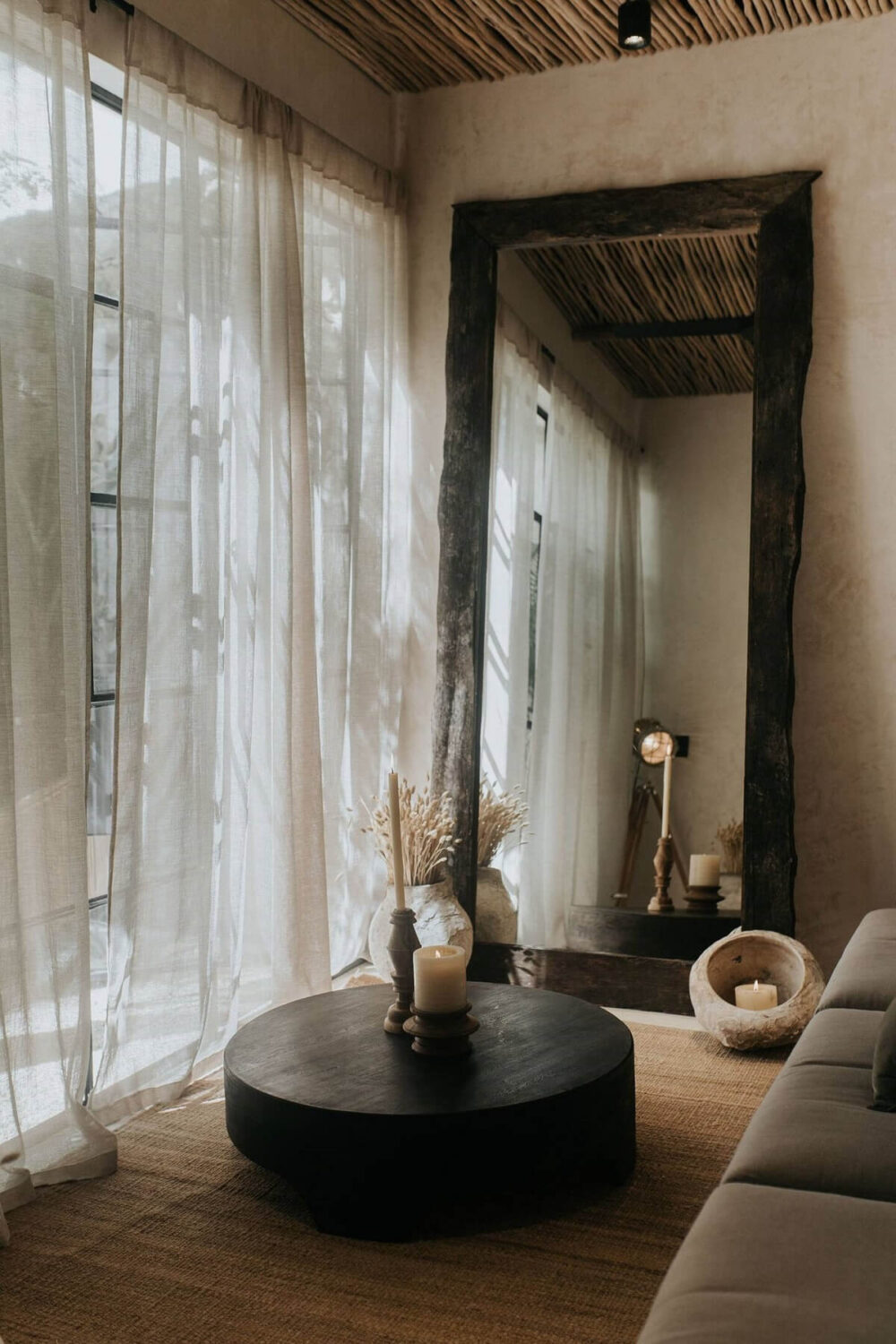 Rustic Wooden Elements in a Stylish Tulum Airbnb 9 round-coffee-table-jute-rug-large-rustic-wooden-mirror-living-room-nordroom