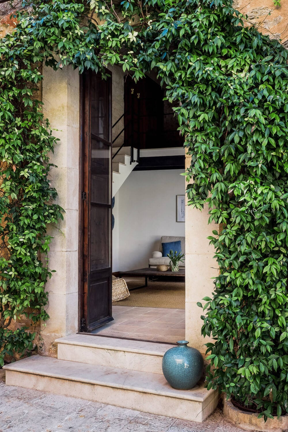 A Renovated Historic Townhouse on Mallorca 3 rustic-wooden-front-door-greenery-mallorca-townhouse-nordroom