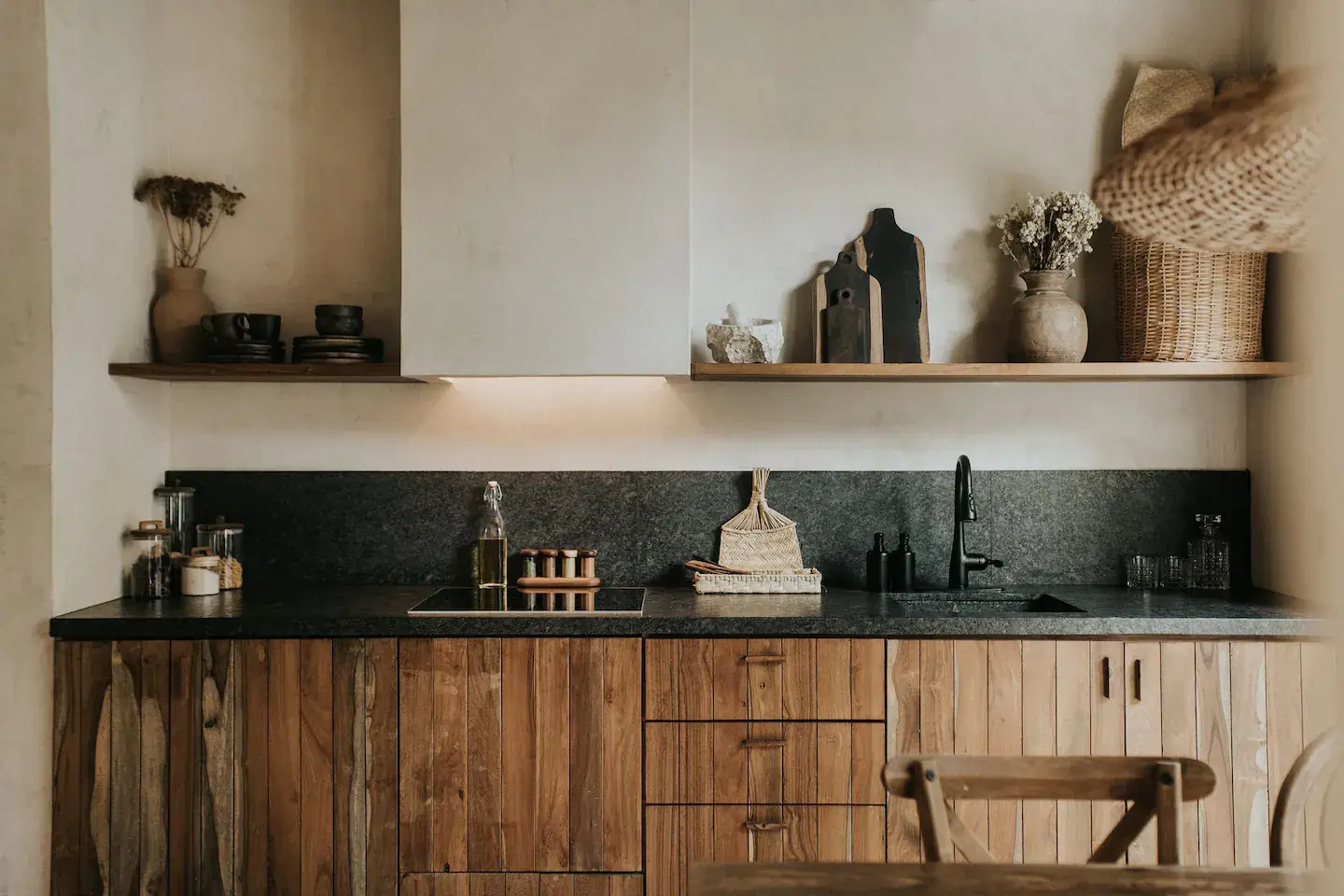 Rustic Wooden Elements in a Stylish Tulum Airbnb 13 rustic-wooden-kitchen-cabinets-black-worktop-backsplash-open-wooden-shelf-nordroom
