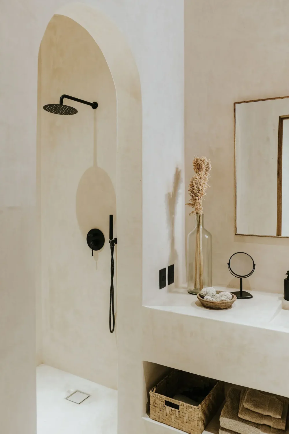 Rustic Wooden Elements in a Stylish Tulum Airbnb 27 serene-bathroom-walk-in-shower-arched-doorway-black-fittings-nordroom
