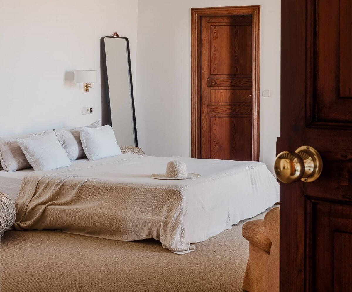 A Renovated Historic Townhouse on Mallorca 15 serene-bedroom-beige-carpet-rustic-wooden-doors-nordroom