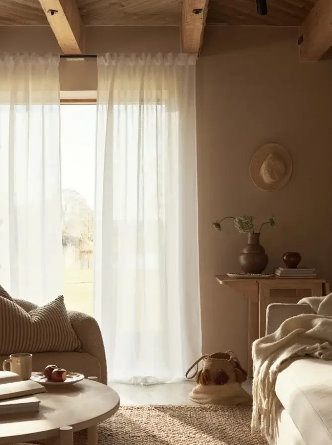 A Serene Summer House in Sweden 2 serene living room jute rug exposed wooden beams nordroom A Serene Summer House in Sweden
