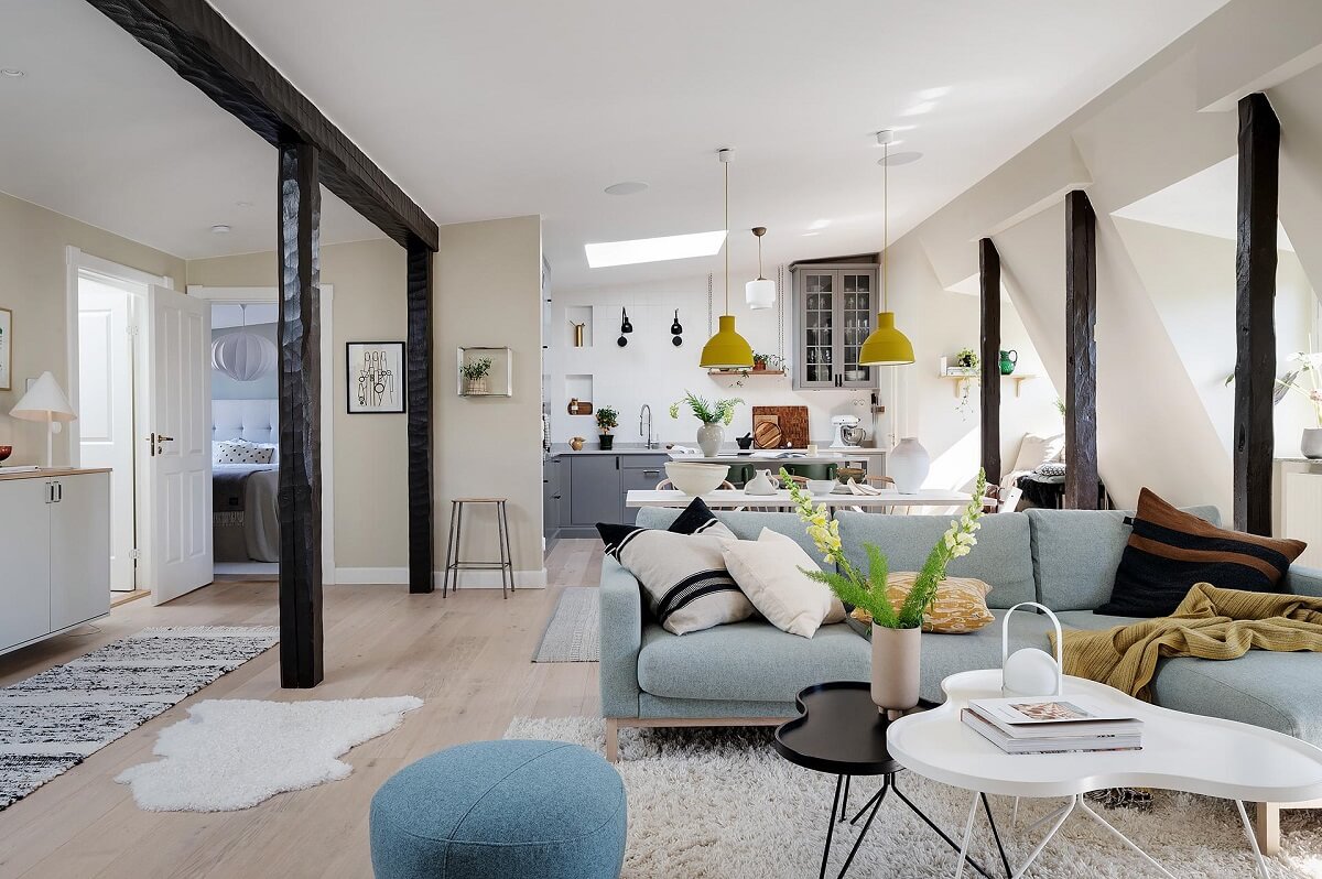 A Modern Scandinavian Attic Apartment 2 social-living-space-light-blue-couch-wooden-beams-nordroom