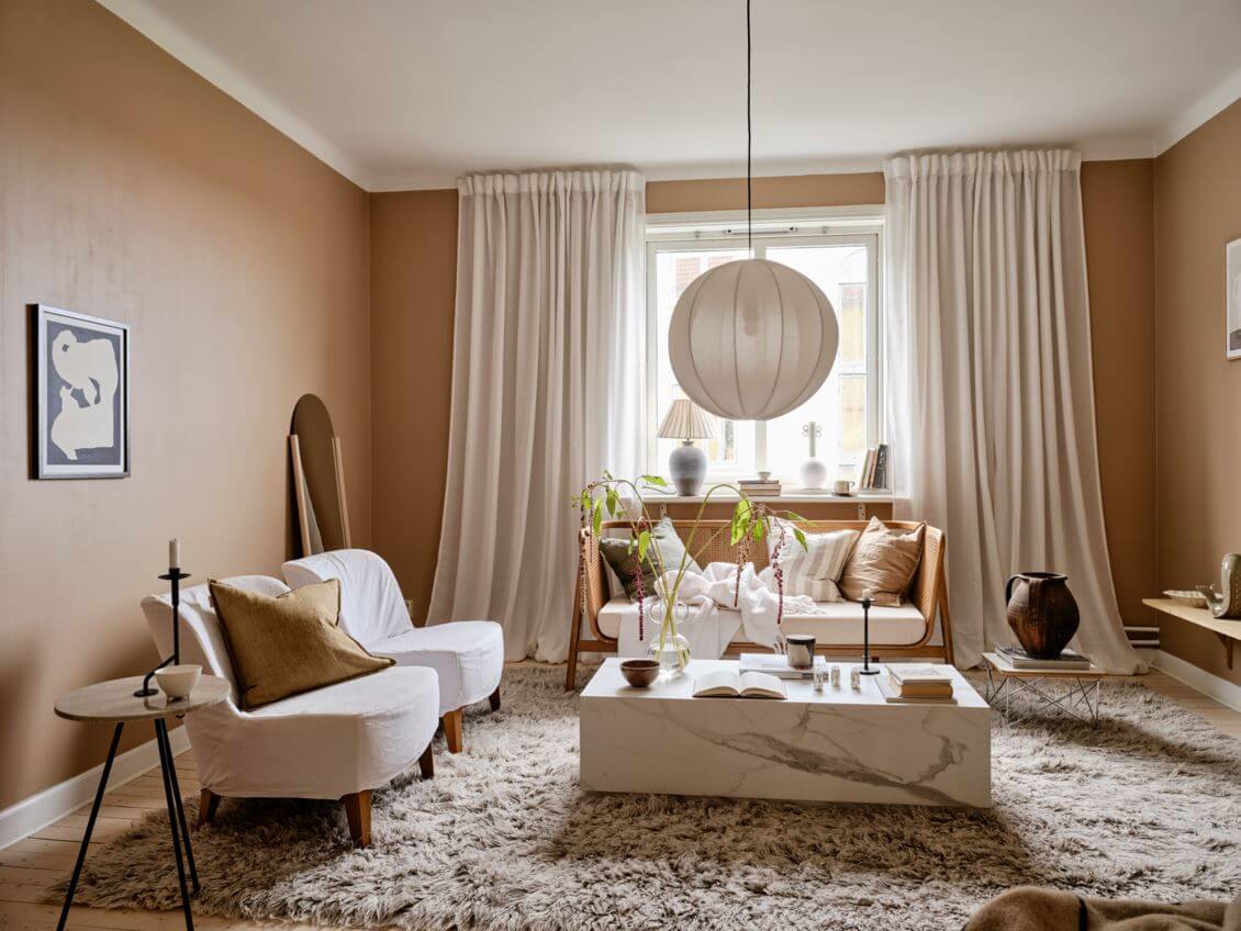 A Warm Beige Studio Apartment in Sweden 5 spacious-seating-area-studio-apartment-large-rug-nordroom