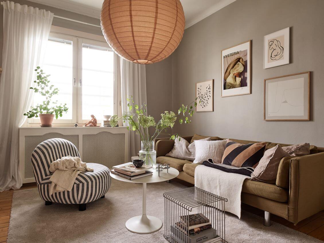 A Small Studio Apartment with Gray Walls 2 studio-apartment-gray-walls-seating-area-green-sofa-striped-armchair-nordroom