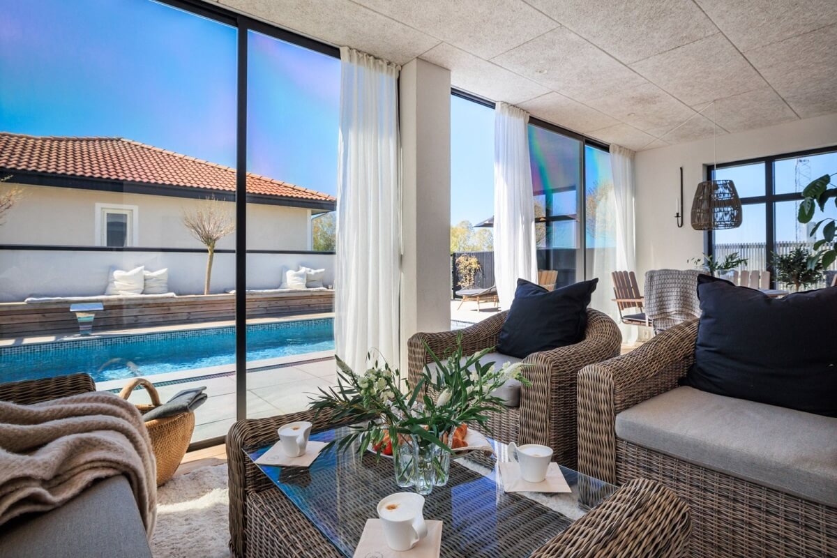 A Monochrome Swedish Villa with High Ceilings 26 sun-room-rattan-seating-nordroom