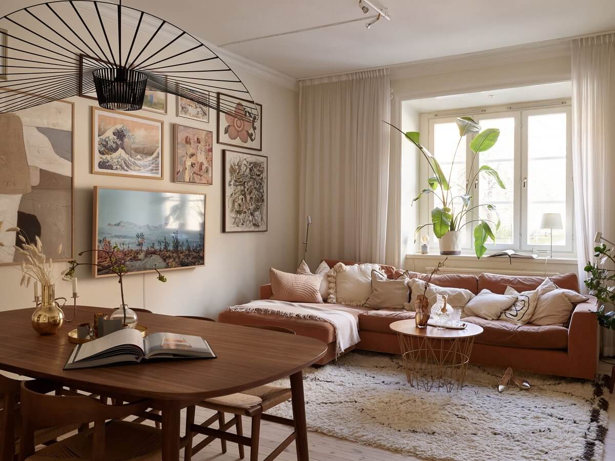 Warm Muted Colors in a Stockholm Apartment 2 warm-beige-living-room-orange-red-sofa-gallery-wall-nordroom