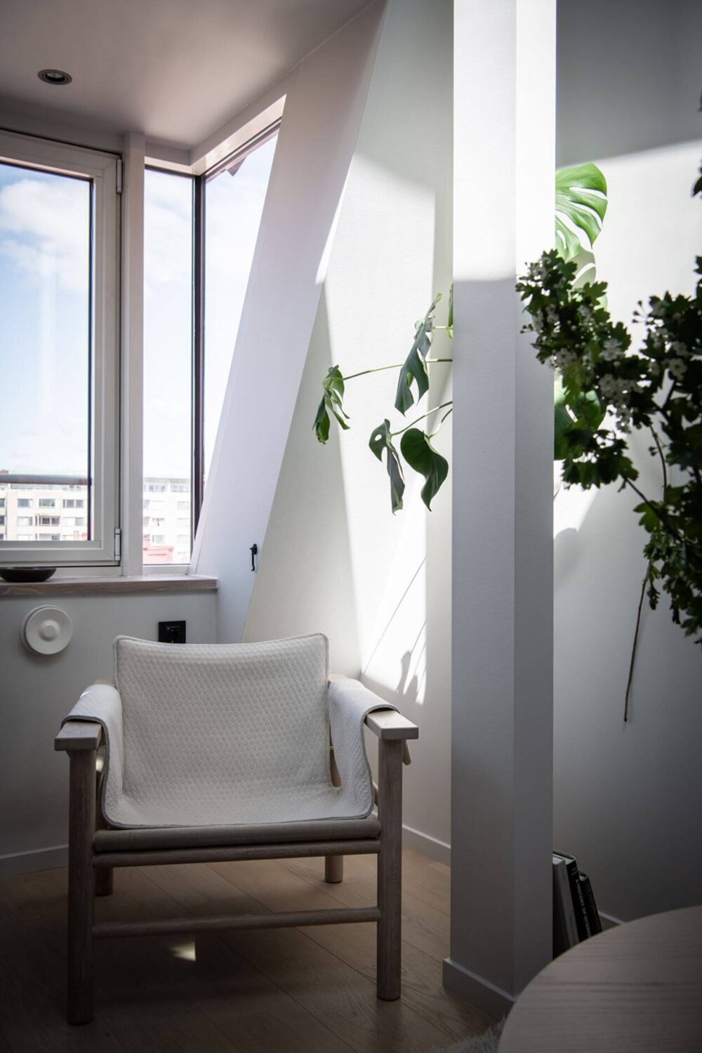 A Stylish Scandinavian Attic Apartment 4 white-armchair-dormer-window-attic-apartment-nordic-design-nordroom