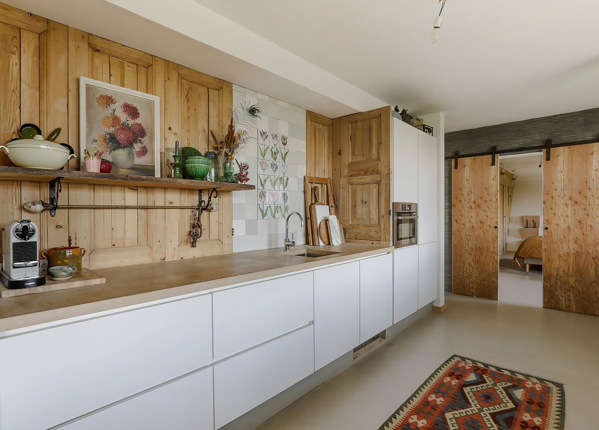 A Unique Upside Down House in The Netherlands 13 white-modern-kitchen-wooden-doors-wall-feature-antque-tiles-nordroom