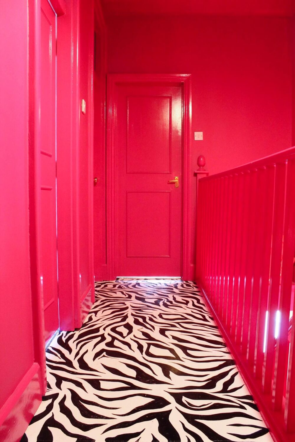 Barbiecore Interiors: The New Colorful & Fun Design Trend 7 barbiecore-interiors-hot-pink-hallway-black-white-patterned-floor-nordroom