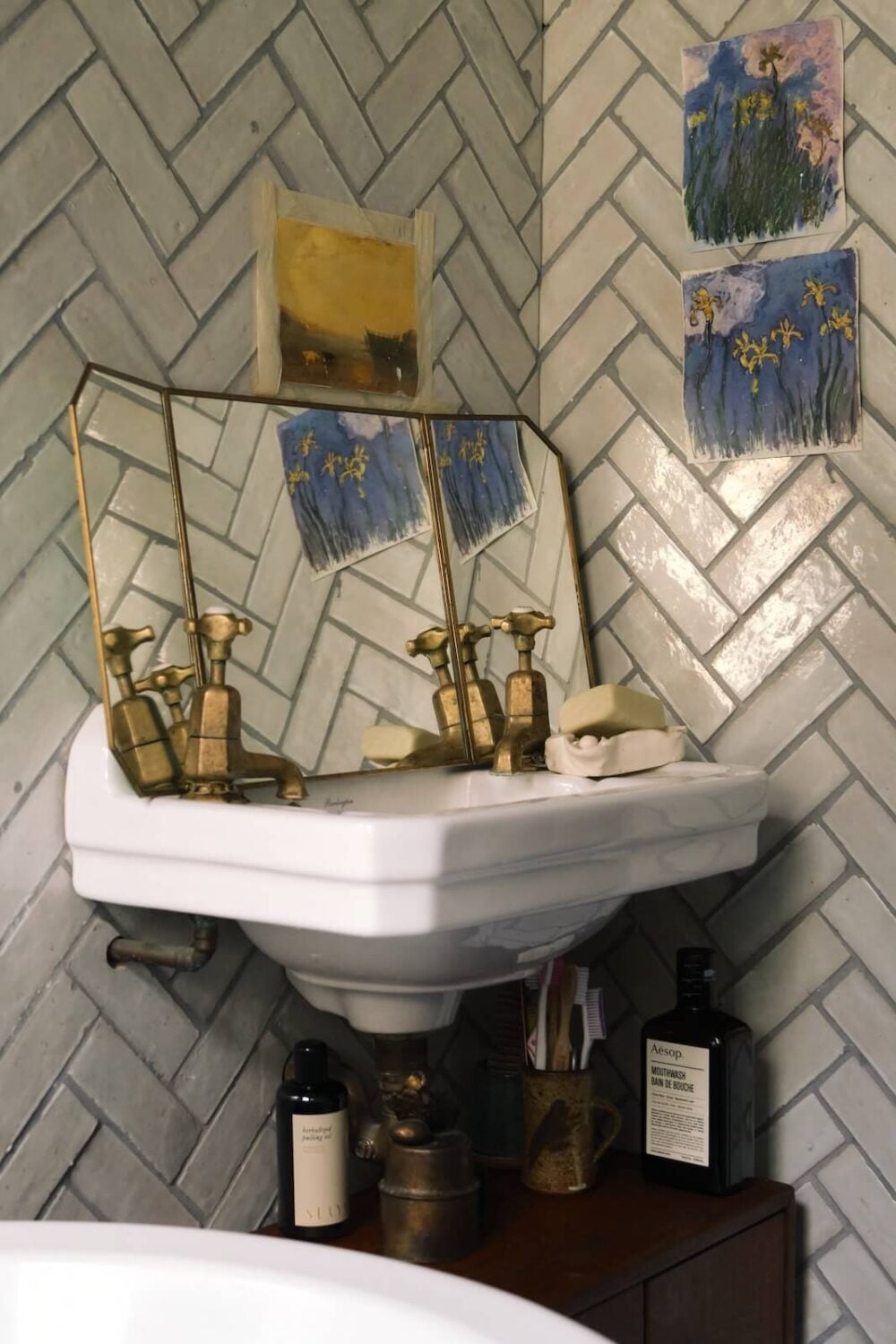 Bold Colors and Historic Details in a Victorian Apartment 16 bathroom-white-herringbone-tiles-antique-mirror-nordroom