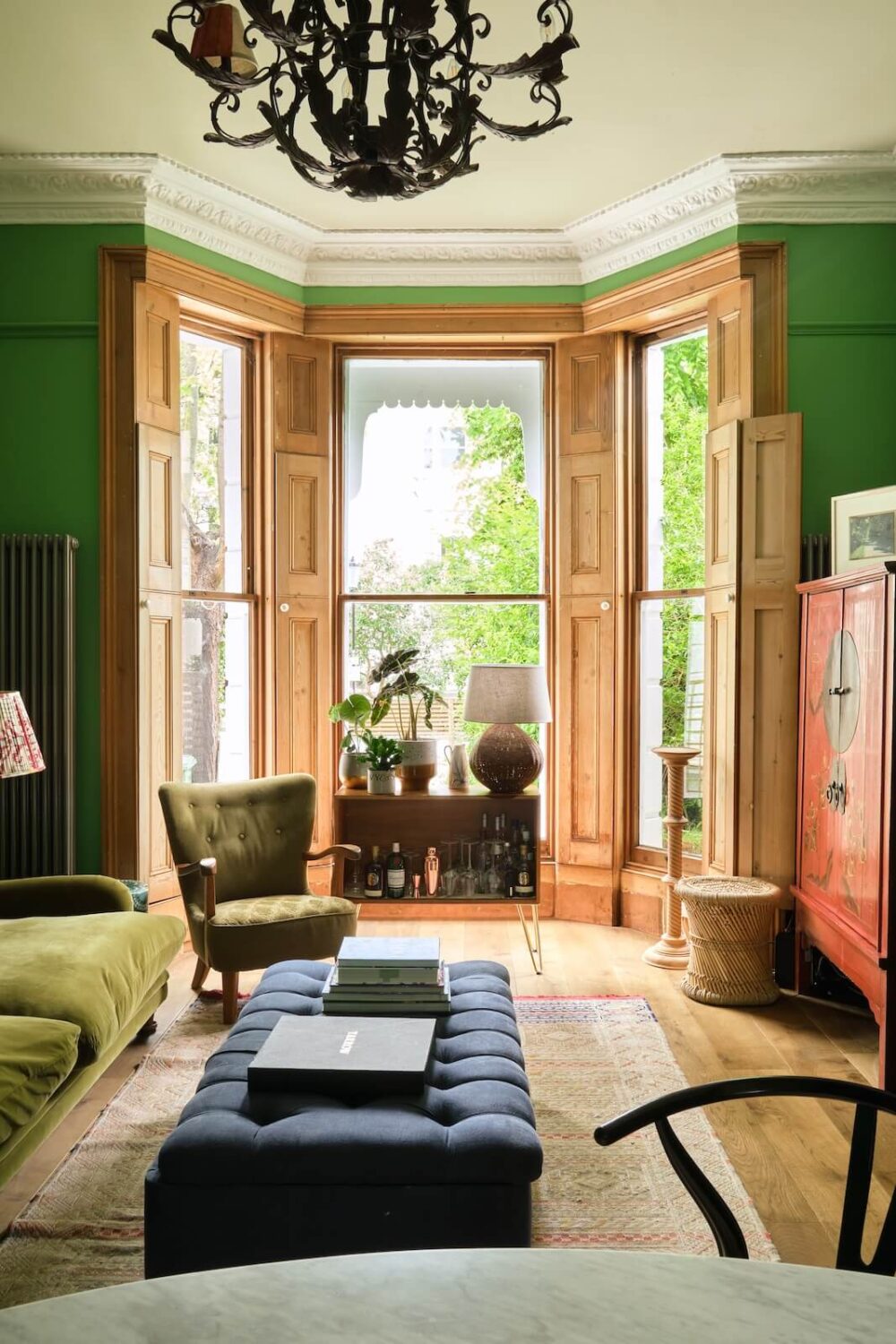Bold Colors and Light Rooms in a Historic Apartment 2 bay-window-living-room-green-walls-farrow-ball-nordroom
