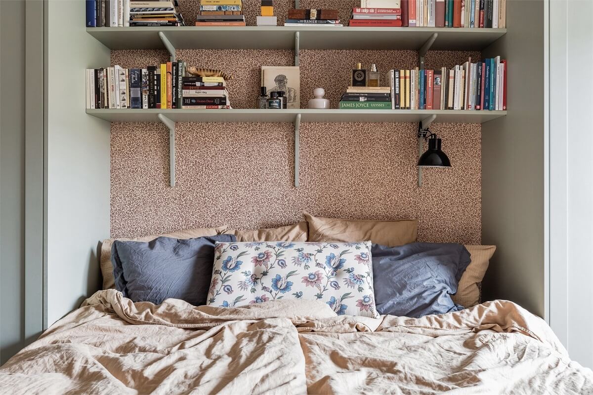 A Warm Scandinavian Apartment Filled with Books & Plants 11 bed-between-built-in-wardrobes-shelves-nordroom