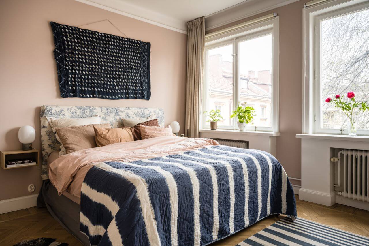 Green Color Accents in a Beautiful Historic Apartment 14 bedroom-blue-white-striped-throw-nordroom
