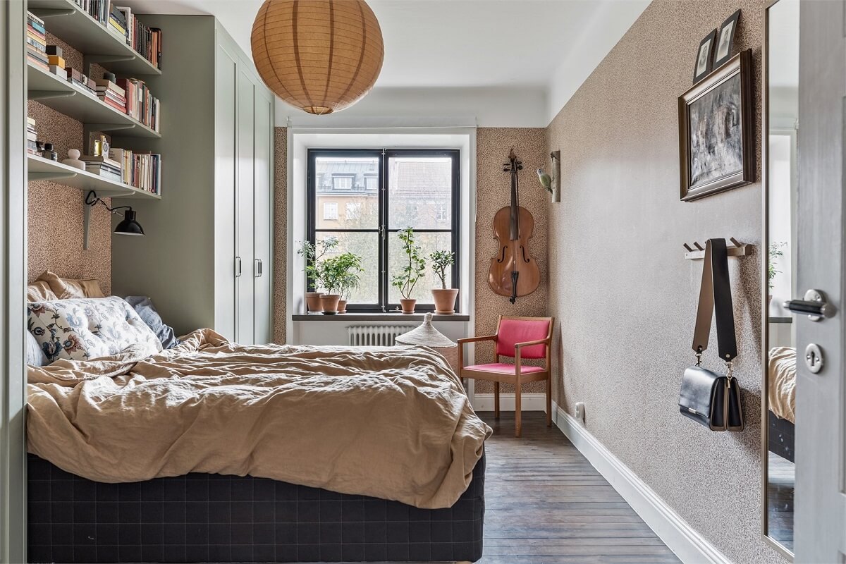 A Warm Scandinavian Apartment Filled with Books & Plants 10 bedroom-wallpaper-built-in-wardrobes-bookshelves-nordroom