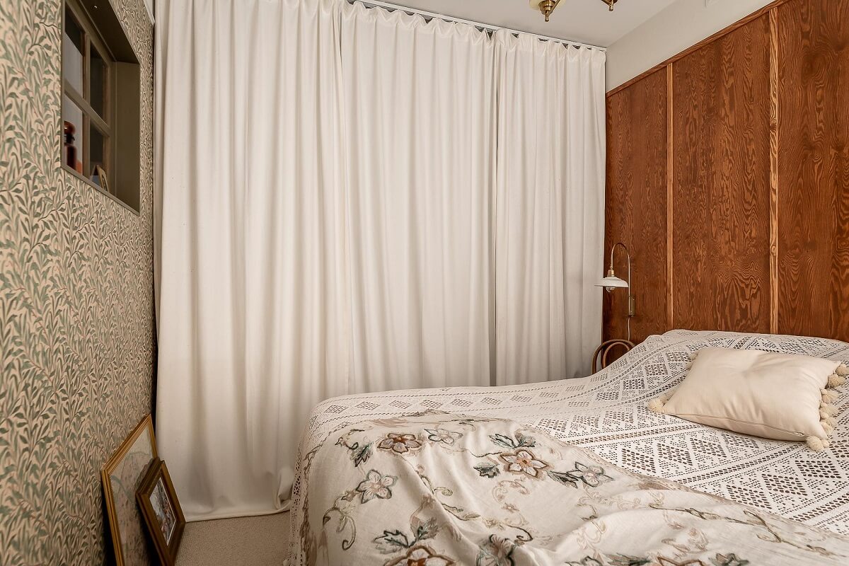A Bright Swedish Apartment with William Morris Wallpaper 14 bedroom-wardrobes-behind-curtain-wooden-accent-wall-nordroom
