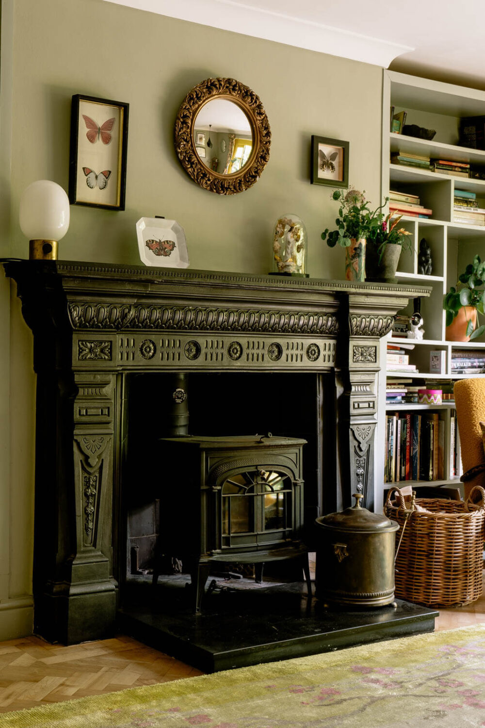 A London Home with Color Accents and a Secret Garden Shed 6 black-carved-fireplace-green-living-room-nordroom