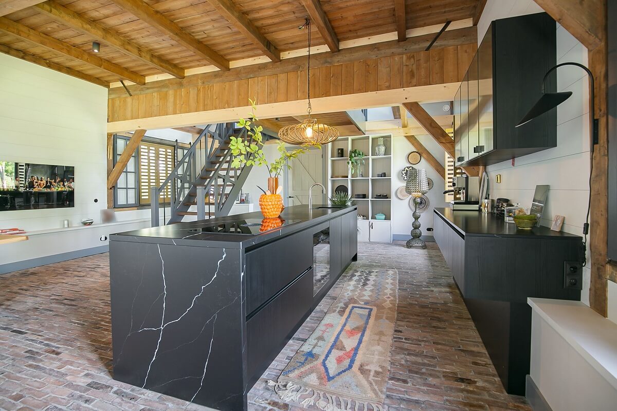 A Dutch Barn House with Brick Floors and Wooden Ceilings 11 black-marble-kitchen-island-wooden-ceiling-nordroom (2)