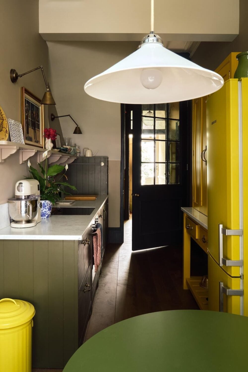 Bold Colors and Light Rooms in a Historic Apartment 10 bright-yellow-kitchen-cabinet-nordroom