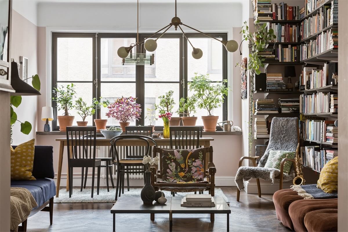 A Warm Scandinavian Apartment Filled with Books & Plants 5 cozy-living-room-bookshelves-dining-table-nordroom