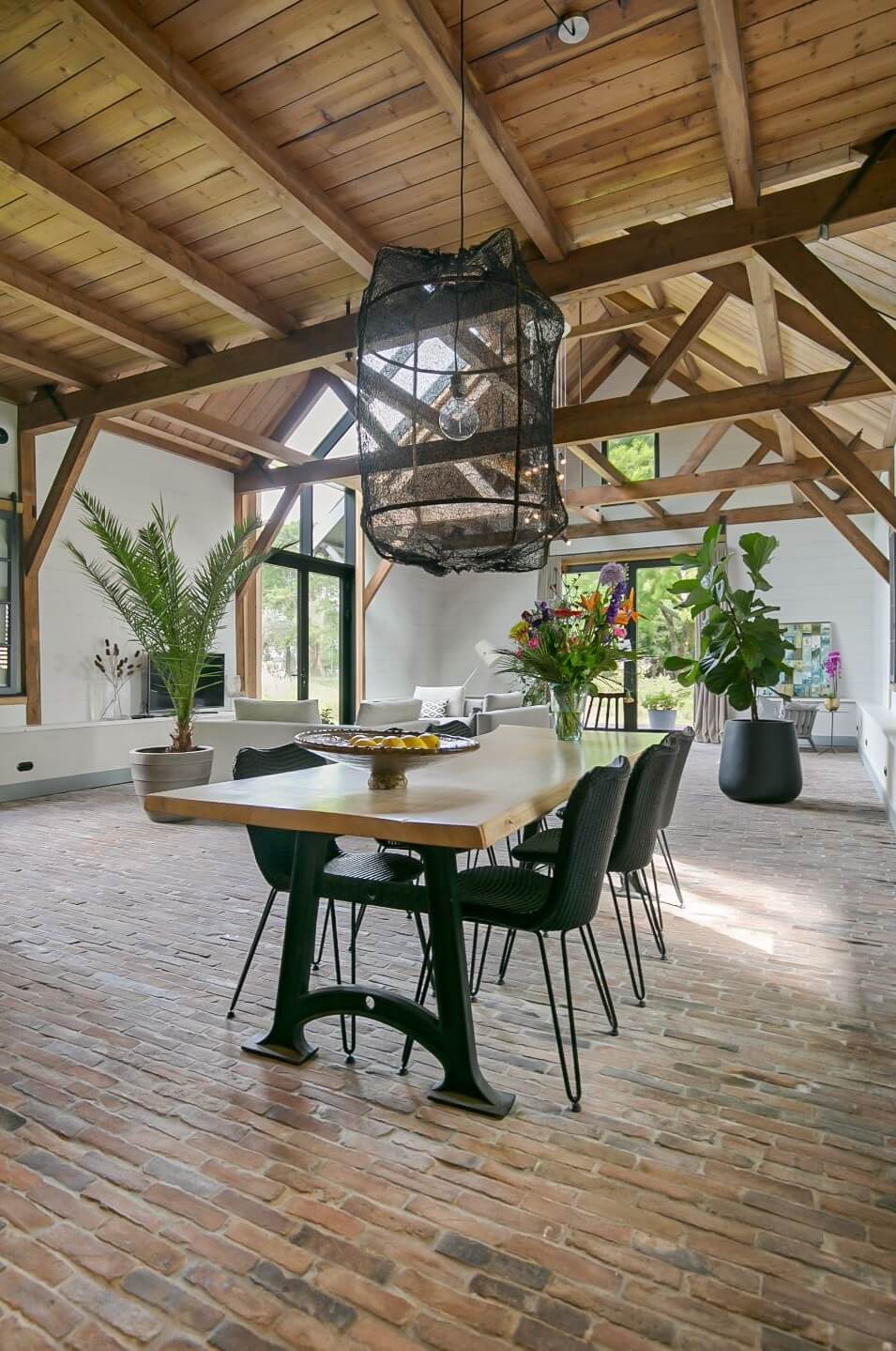 A Dutch Barn House with Brick Floors and Wooden Ceilings 9 dining-table-living-space-wooden-ceiling-nordroom