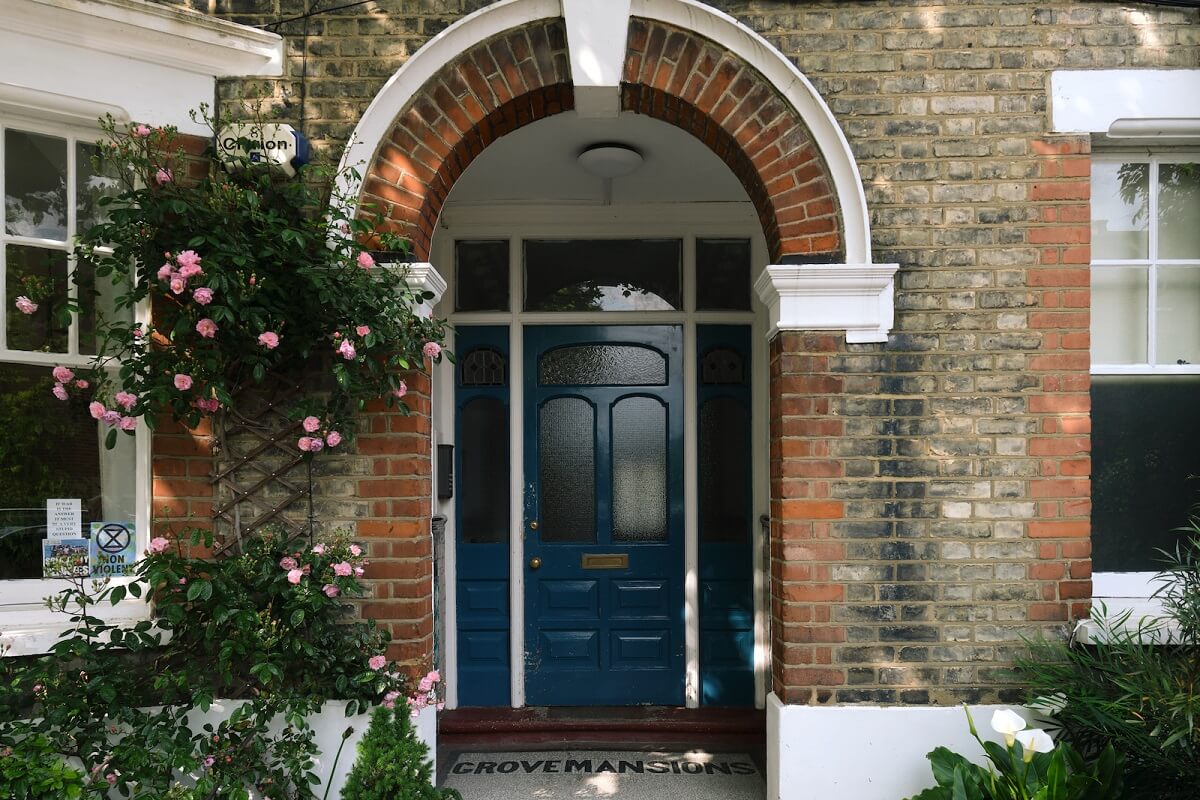 Bold Colors and Historic Details in a Victorian Apartment 17 entry-arched-doorway-blue-front-door-nordroom