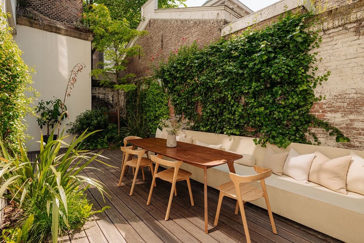 A Modern Home in a Historic Amsterdam Canal House 12 garden-dining-space-built-in-desk-plants-nordroom