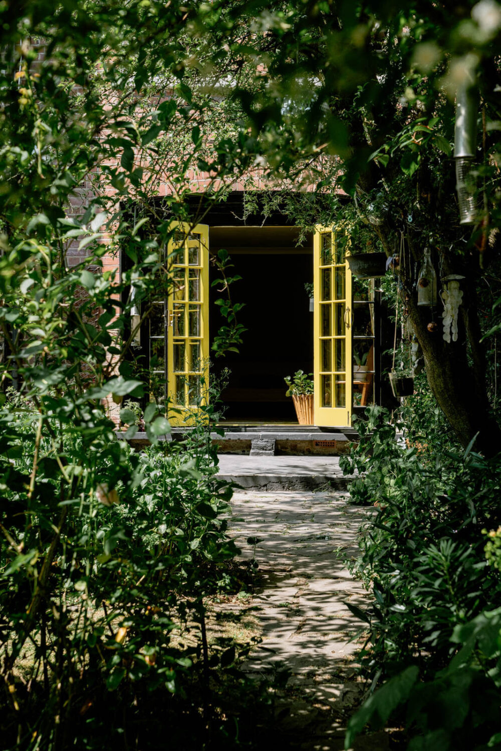 A London Home with Color Accents and a Secret Garden Shed 18 garden-yellow-double-doors-london-apartment-nordroom