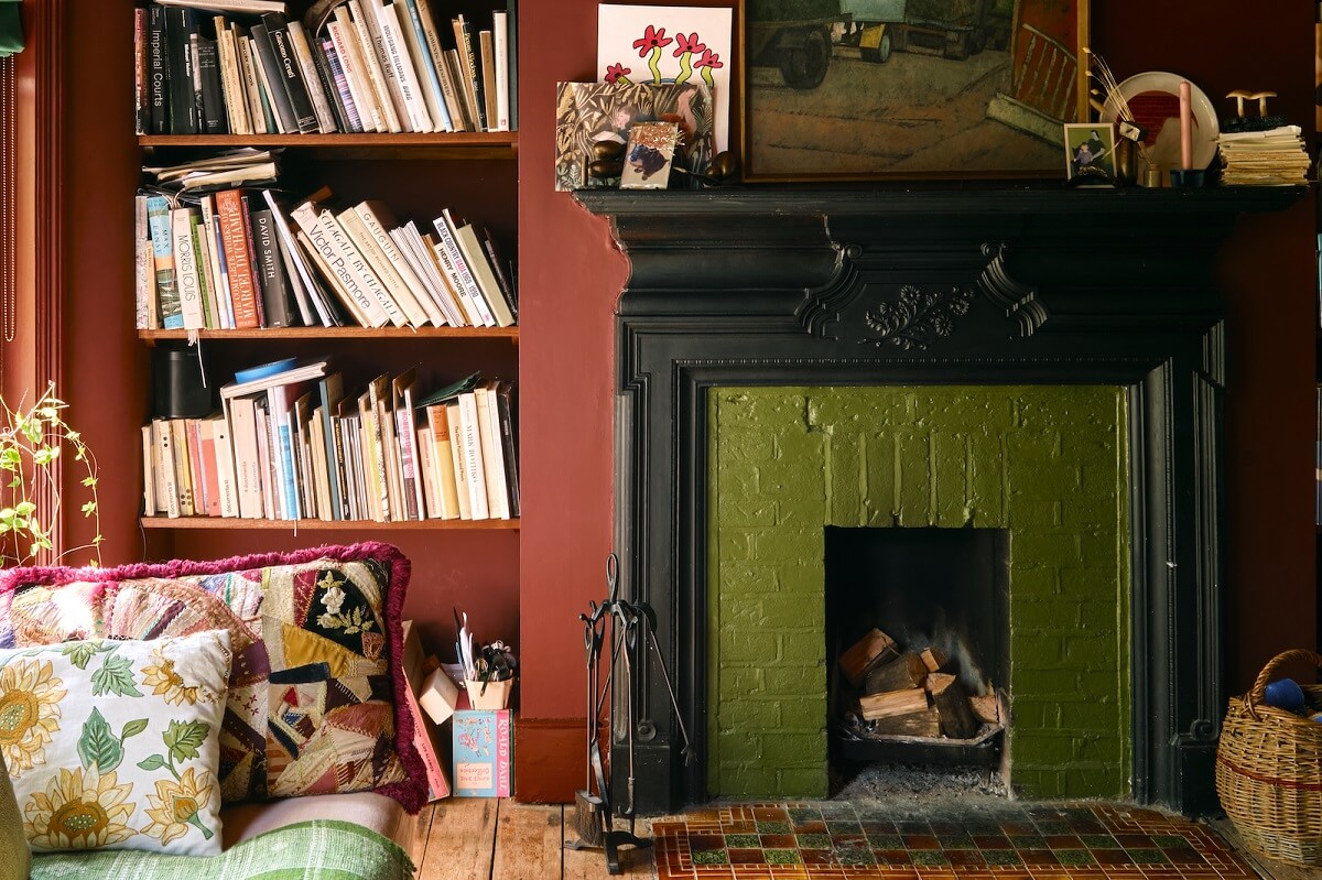 Bold Colors and Historic Details in a Victorian Apartment 3 green-painted-brick-fireplace-bookshelves-nordroom