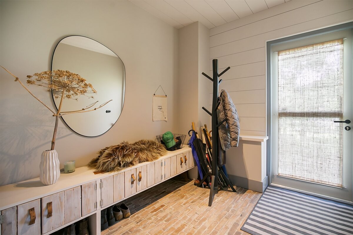 A Dutch Barn House with Brick Floors and Wooden Ceilings 13 hallway-round-mirror-low-cabinets-nordroom