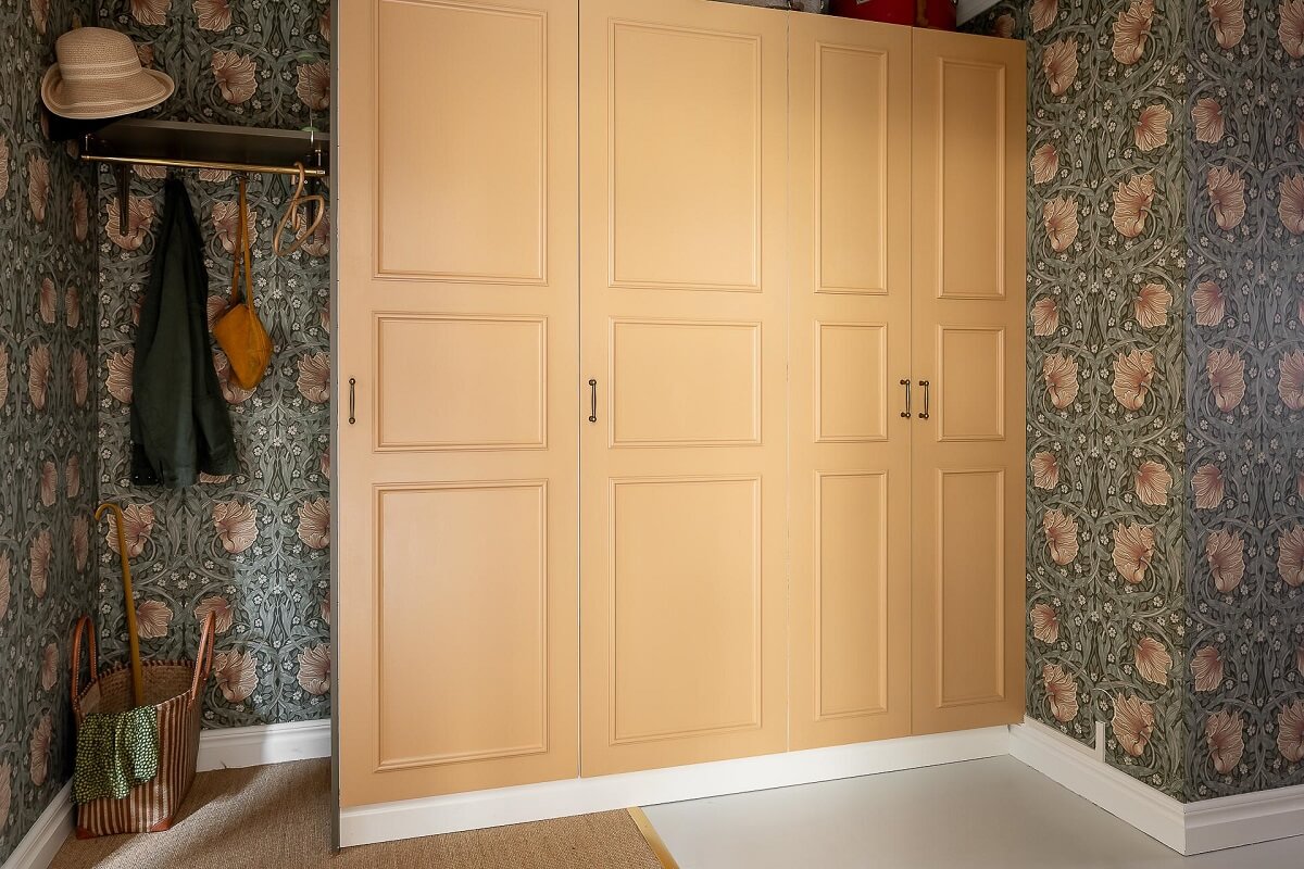 A Bright Swedish Apartment with William Morris Wallpaper 17 hallway-william-morris-wallpaper-yellow-storage-cabinets-nordroom