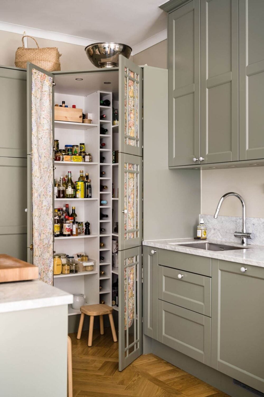 Green Color Accents in a Beautiful Historic Apartment 11 kitchen-small-pantry-with-glass-doors-covered-with-fabric-nordroom
