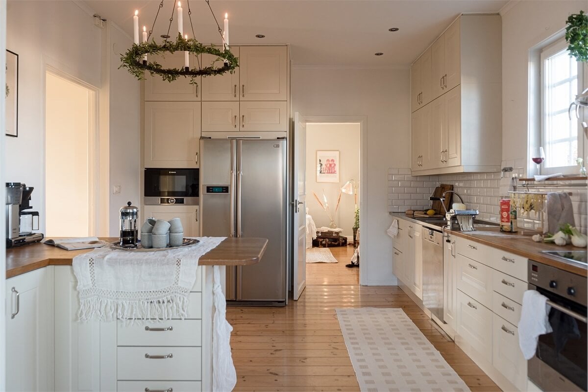 Natural Light in a Family Home in Sweden 9 kitchen-white-cabinets-wooden-floorboards-nordroom