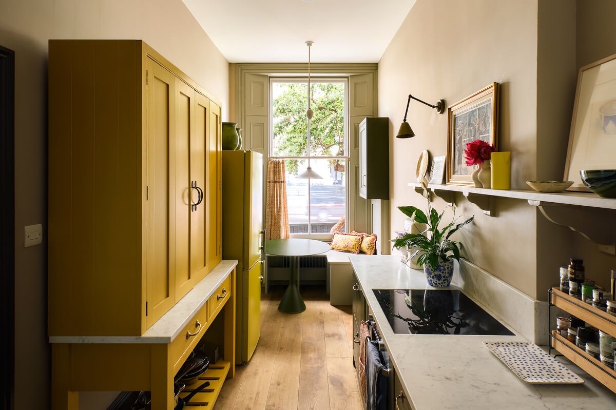 Bold Colors and Light Rooms in a Historic Apartment 7 kitchen-window-seat-yellow-cabinet-nordroom