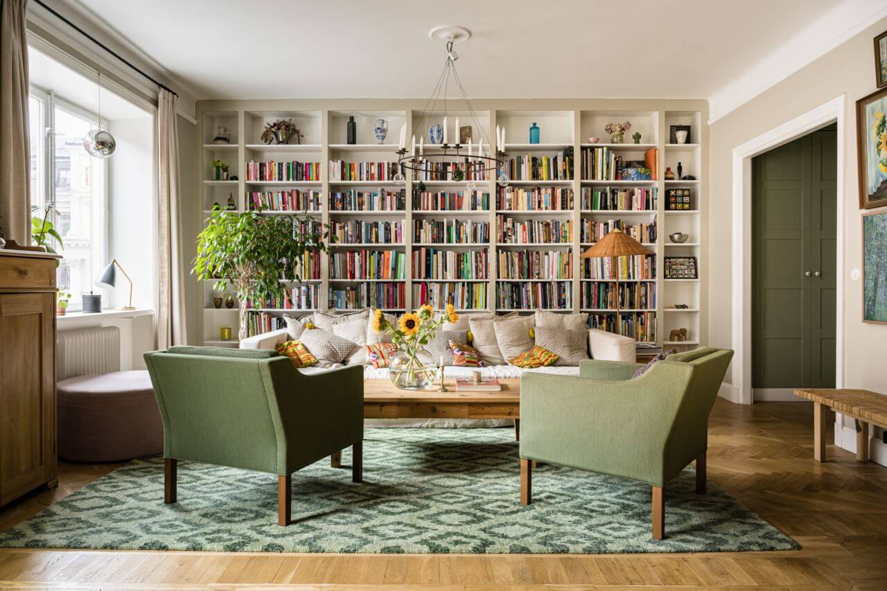 Green Color Accents in a Beautiful Historic Apartment 1 living-room-bookshelves-green-armchairs-nordroom
