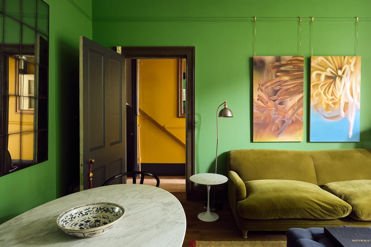 Bold Colors and Light Rooms in a Historic Apartment 6 living-room-emerald-green-walls-mustard-yellow-hallway-black-door-nordroom