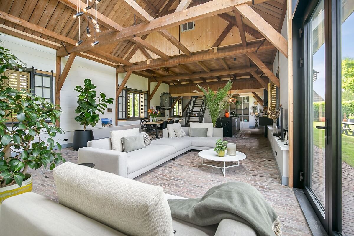A Dutch Barn House with Brick Floors and Wooden Ceilings 1 living-room-plants-brick-floor-wooden-ceiling-nordroom