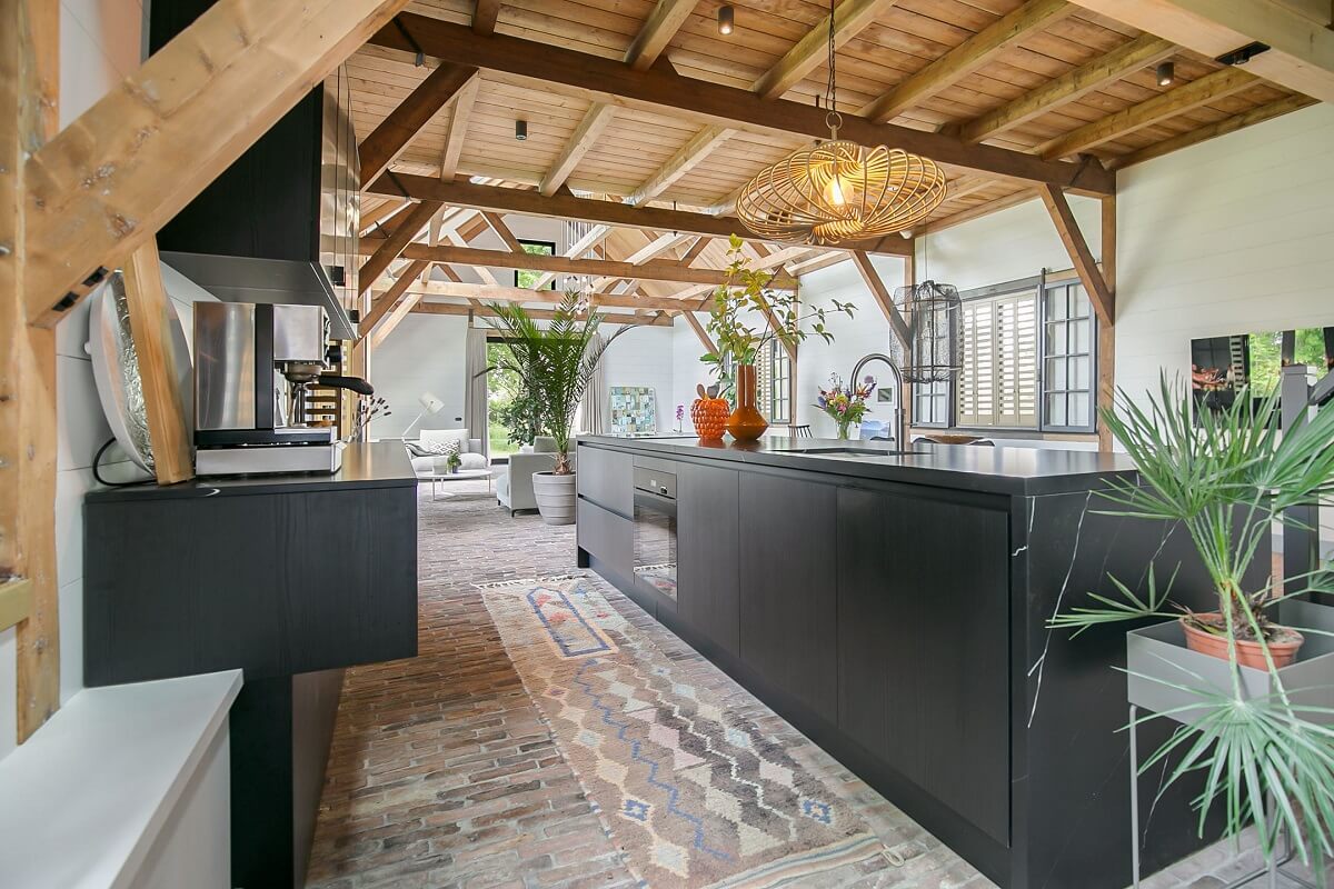 A Dutch Barn House with Brick Floors and Wooden Ceilings 8 modern-black-kitchen-brick-floor-nordroom