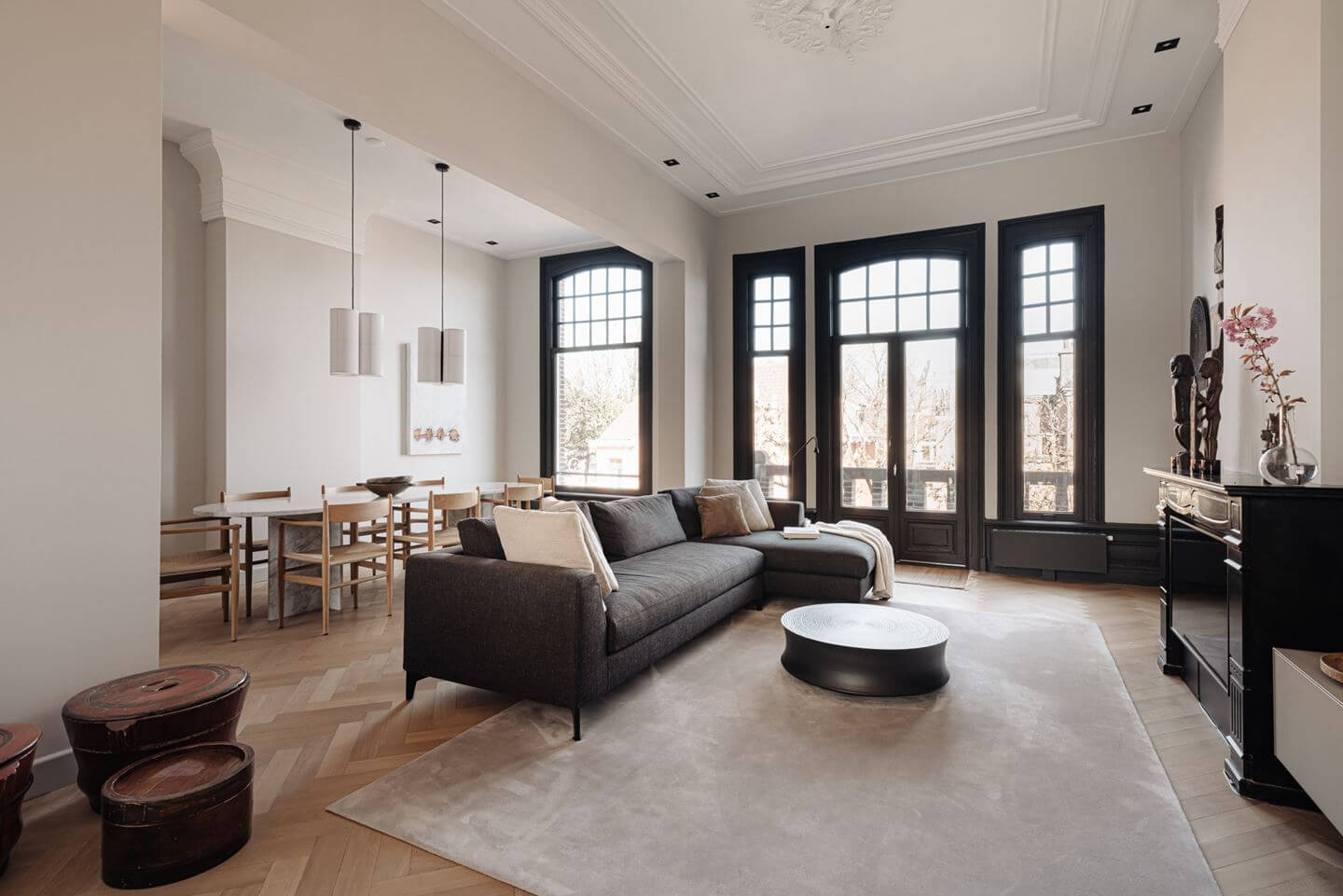 A Monochrome Duplex Apartment in Amsterdam 1 monochrome-living-room-dark-gray-sofa-large-rug-dining-table-nordroom