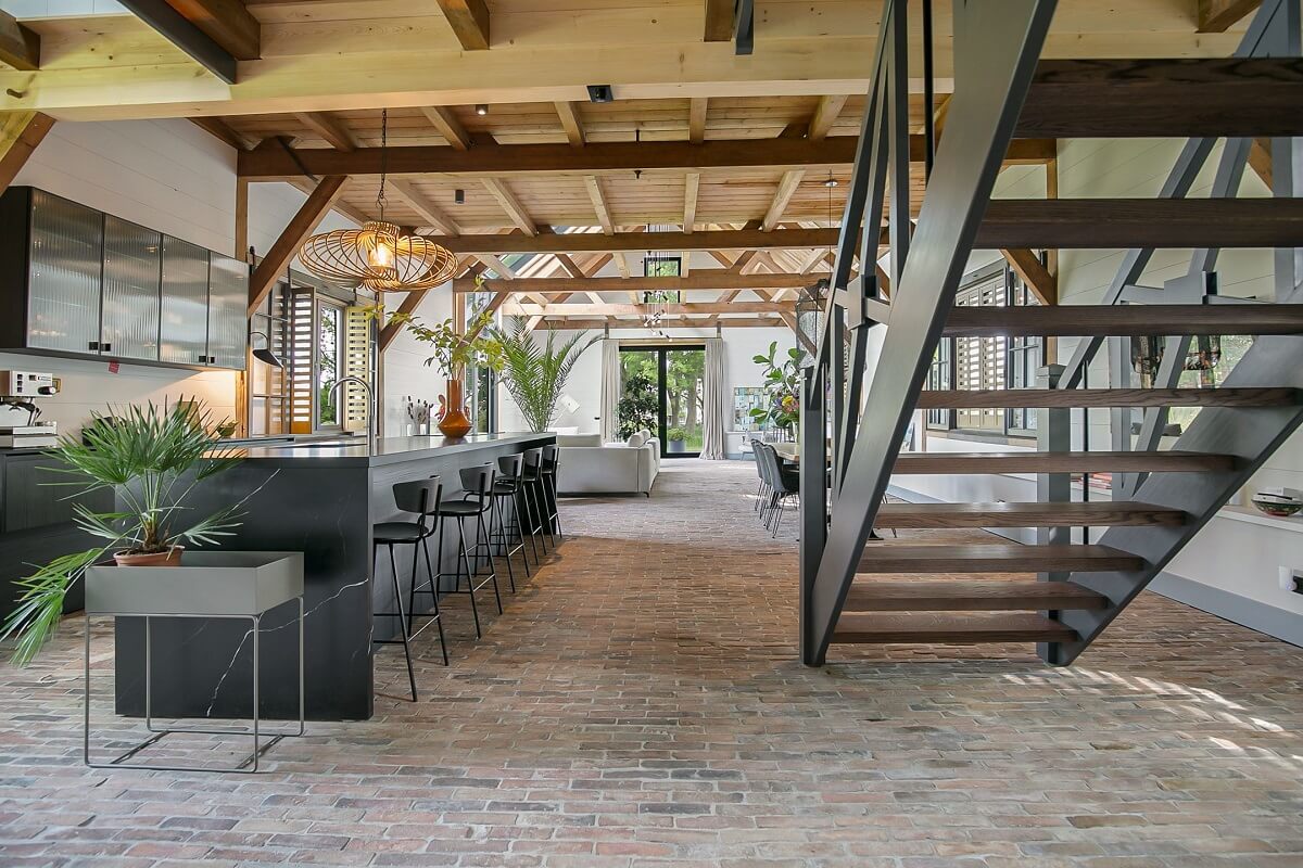 A Dutch Barn House with Brick Floors and Wooden Ceilings 7 open-plan-barn-house-steel-stair-nordroom