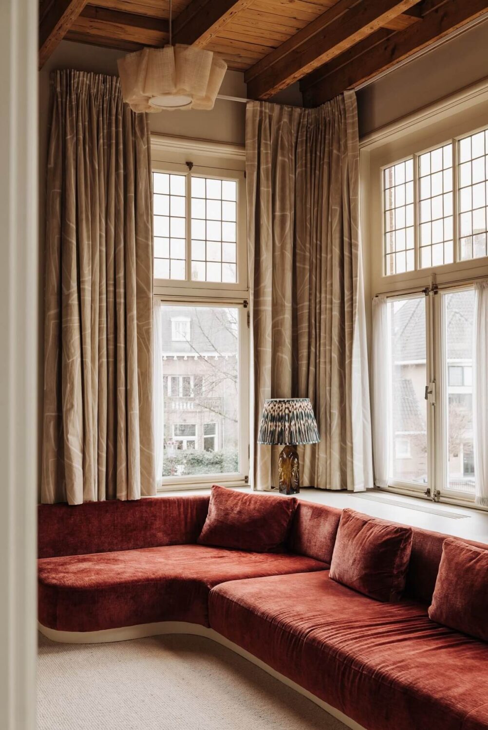 A Grand Renovated Family Home in Amsterdam 16 sitting-room-built-in-couch-red-velvet-upholstery-nordroom