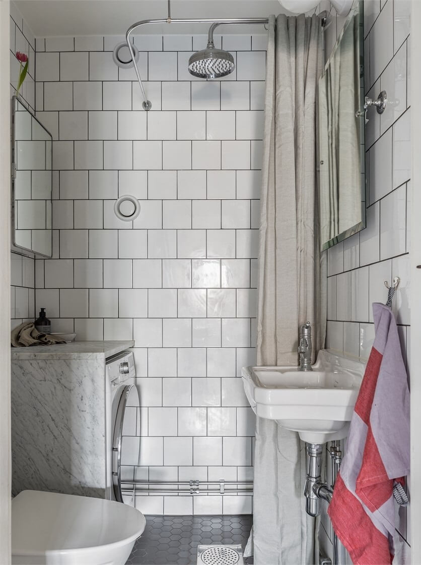 A Warm Scandinavian Apartment Filled with Books & Plants 17 small-bathroom-white-tiles-nordroom